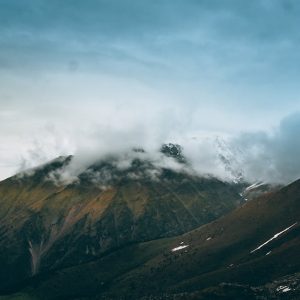 Mountain Landscapes - A stunning view of mountain peaks partially cove #12211339