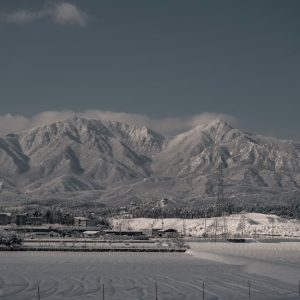 Snow Mountains - Snow-capped mountains rise above a serene town,  #15201467