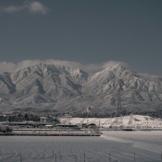 Snow Mountains - Snow-capped mountains rise above a serene town,  #15201467