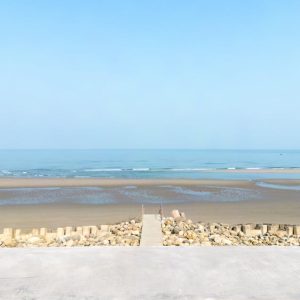 Beach Scenery - Serene coastal view with clear blue sky and a co #15902767