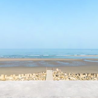 Beach Scenery - Serene coastal view with clear blue sky and a co #15902767