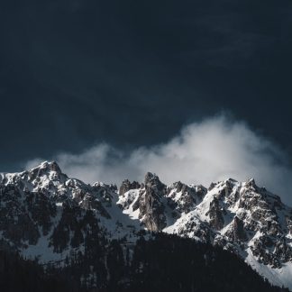 Snow Mountains - Stunning snowy mountain peaks under a dramatic d #16530781