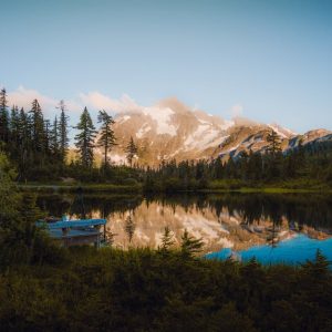 Lake Reflections - A peaceful mountain lake reflecting trees and sn #17841936