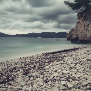 Beach Scenery - Stormy skies over a pebbled beach in Portoferrai #18582298