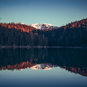 Lake Reflections - A tranquil lake reflects snowcapped mountains an #20755869
