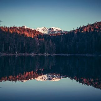 Lake Reflections - A tranquil lake reflects snowcapped mountains an #20755869