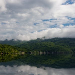 Lake Reflections - Peaceful lake with lush green hills and clouds r #25391558