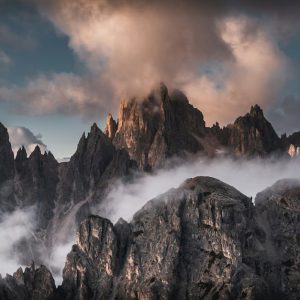 Mountain Landscapes - Majestic mountain peaks shrouded in mist at suns #28127040