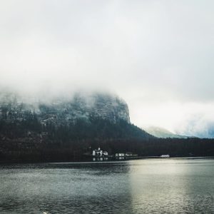 Lake Reflections - Serene lake with misty mountain backdrop and clo #28593673