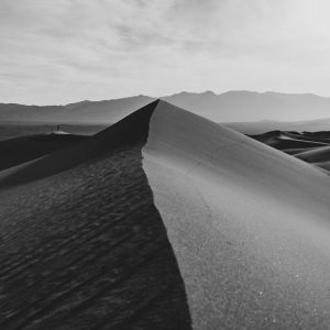 Desert Wilderness - Monochrome image of sand dunes with mountains in #28639219
