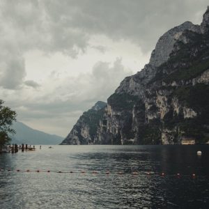 Lake Reflections - Serene view of Lake Garda with imposing cliffs a #32049157