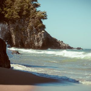 Beach Scenery - Waves crash on a tranquil rocky beach under a cl #33596216