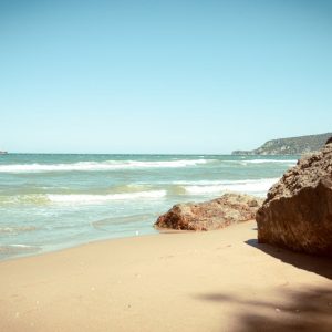 Beach Scenery - A tranquil beach scene featuring a rocky outcrop #33596222