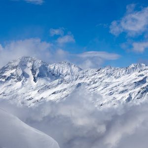 Snow Mountains - Snow-covered mountains with blue sky and clouds  #36524855