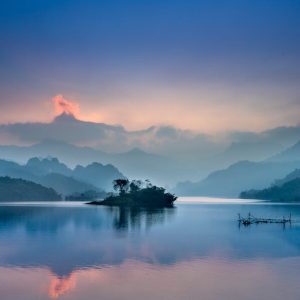 Lake Reflections - Peaceful lake scene at sunrise with misty mounta #6346489