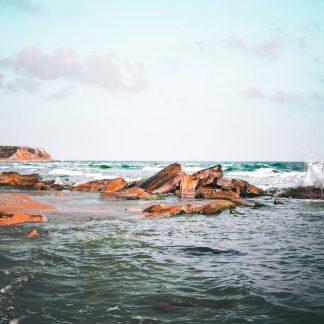 Beach Scenery - A tranquil beach scene featuring a rocky shoreli #7469959